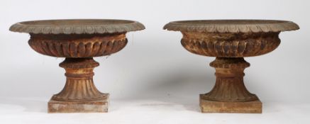 A PAIR OF CAST IRON GARDEN URNS.