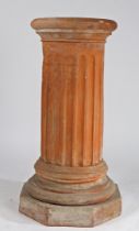 A THOMAS & CO TERRACOTTA PEDESTAL.