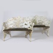 A PAIR OF COALBROOKDALE STYLE CAST IRON FERN AND BLACKBERRY PATTERN GARDEN BENCHES.