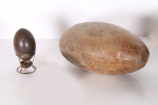 A CARVED EMU EGG AND A SUBSTANTIAL SEED POD.