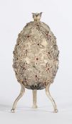 A RUSSIAN SILVER NOVELTY EGG. THE BODY SET WITH GARNETS AND A PEARL FINISH.
