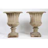 A PAIR OF CAST IRON GARDEN URNS.