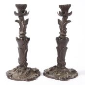 A PAIR OF VICTORIAN BRONZE CANDLESTICKS.