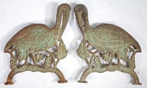 A PAIR OF VICTORIAN CAST IRON BENCH ENDS MODELLED AS CRANES.