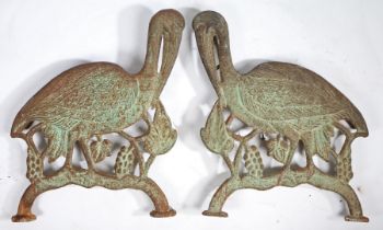 A PAIR OF VICTORIAN CAST IRON BENCH ENDS MODELLED AS CRANES.