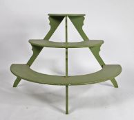 A DEMI-LUNE THREE TIER PLANT STAND.