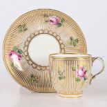 MINTON CUP AND SAUCER DECORATED WITH ROSES ON GOLD STRIPED GROUND.