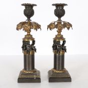 A PAIR OF REGENCY STYLE STEEL AND GILT METAL CANDLESTICKS.