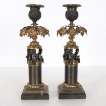 A PAIR OF REGENCY STYLE STEEL AND GILT METAL CANDLESTICKS.