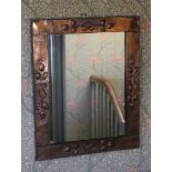 AN ARTS AND CRAFTS COPPER WALL MIRROR.