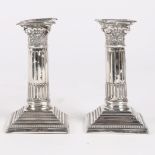 A PAIR OF GEORGE V SILVER DWARF CANDLESTICKS.