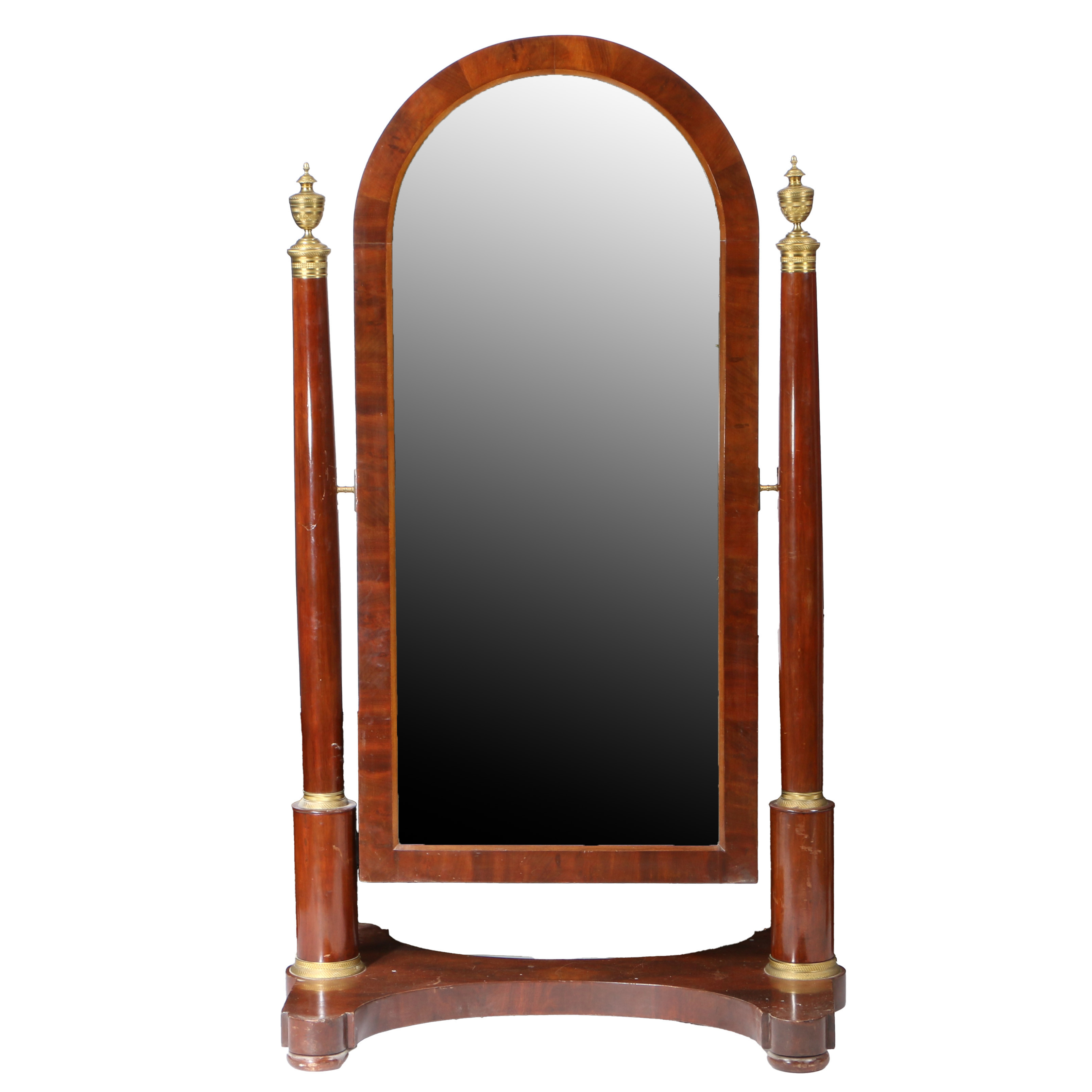 A FRENCH EMPIRE MAHOGANY AND ORMOLU MOUNTED CHEVAL MIRROR.