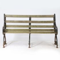 A YATES & HAYWOOD TRIPLE LEGGED CAST IRON GARDEN BENCH.