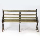 A YATES & HAYWOOD TRIPLE LEGGED CAST IRON GARDEN BENCH.