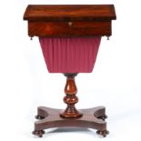 A VICTORIAN ROSEWOOD AND MAHOGANY SEWING TABLE.