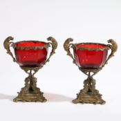A PAIR OF 19TH CENTURY BOHEMIAN RUBY GLASS AND GILT METAL TWIN HANDLED VASES (2).