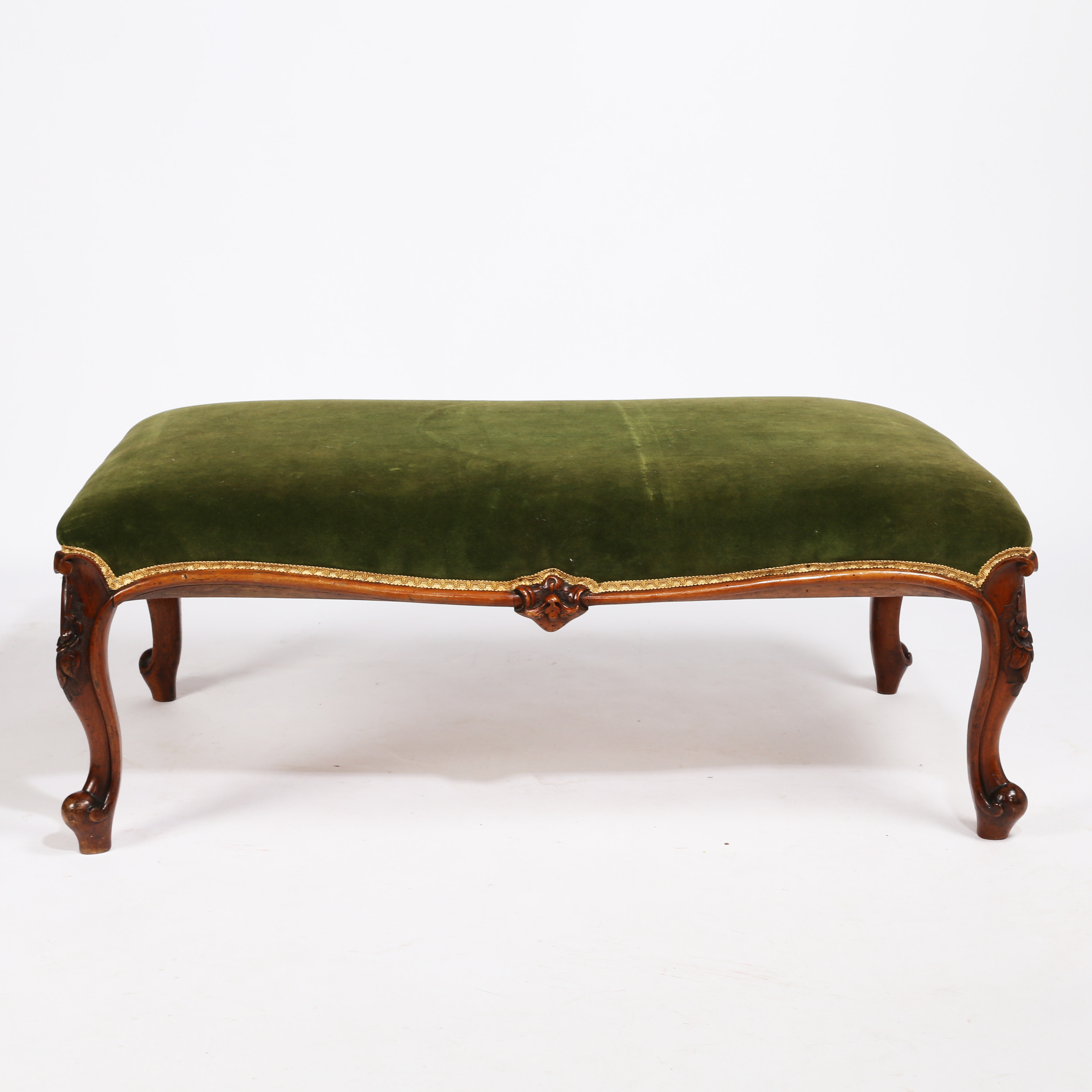 A LARGE 19TH CENTURY WALNUT AND UPHOLSTERED FOOTSTOOL.