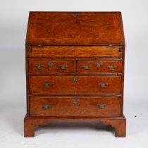 A GEORGE III BURR WALNUT AND FEATHER BANDED BUREAU.