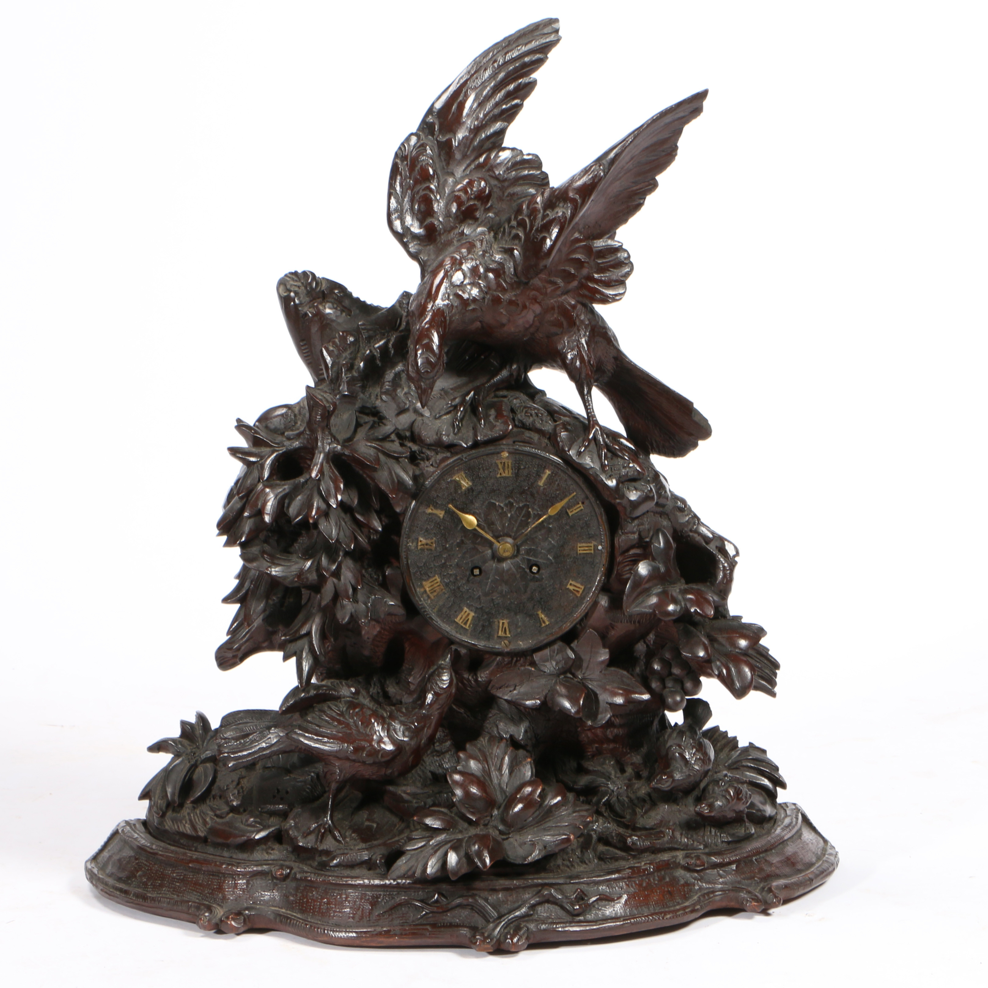 A 19TH CENTURY BLACK FOREST LARGE NATURALISTICALLY CARVED MANTEL CLOCK.