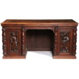 A 19TH CENTURY OAK PEDESTAL DESK, INCORPORATING EARLY 16TH CENTURY PANELS.