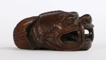 A JAPANESE CARVED WOOD CARP NETSUKE.