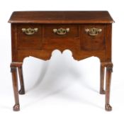 A GEORGE III OAK LOWBOY.