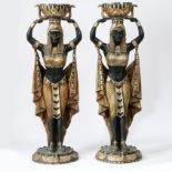 A PAIR OF FLOOR STANDING PLANTERS MODELLED AS CLEOPATRA'S EGYPTIAN NUBIAN MAIDENS.