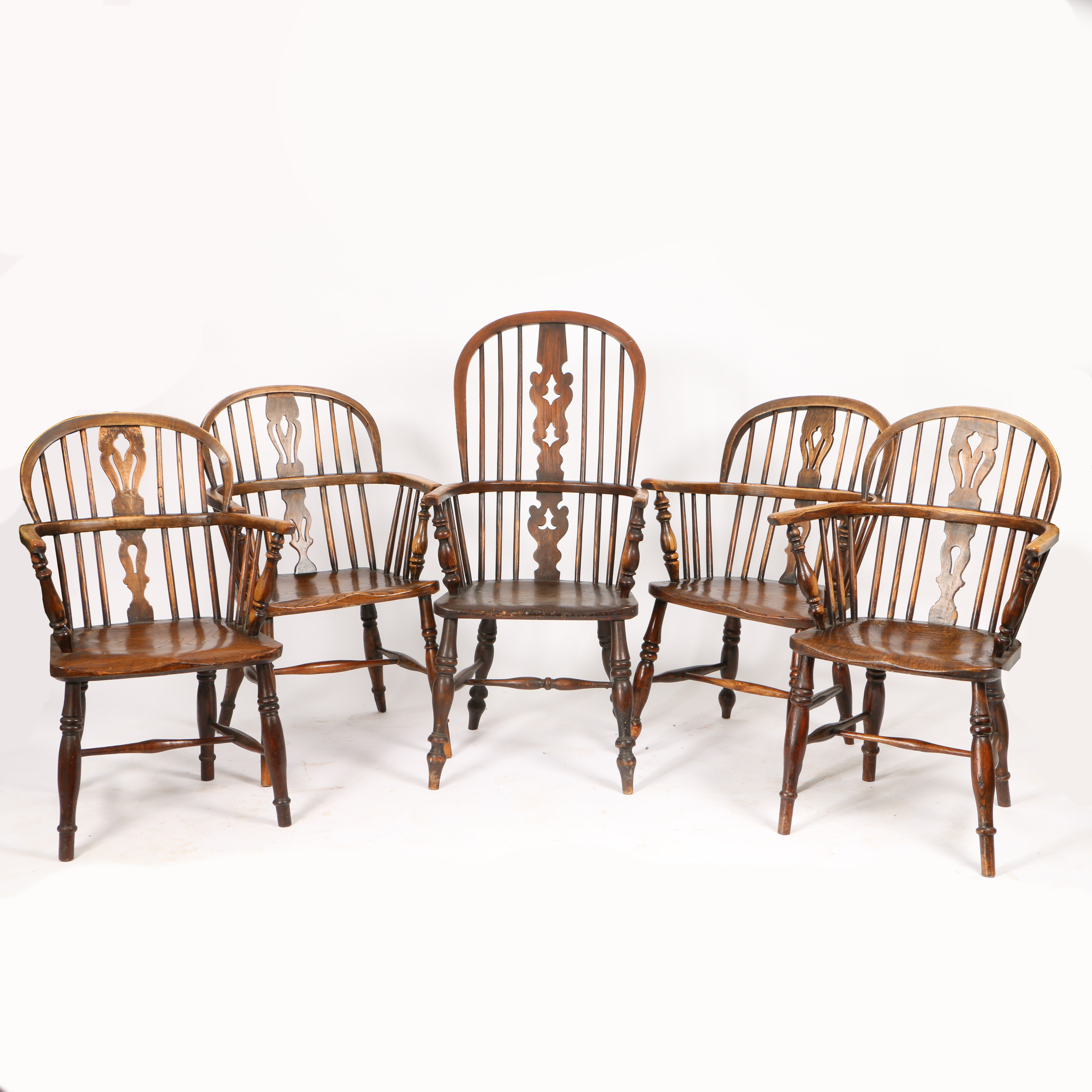 A SET OF FIVE OAK AND ELM WINDSOR ARMCHAIRS.