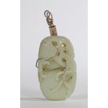 A CHINESE QING DYNASTY CELADON JADE PENDANT.