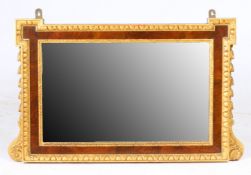 A 19TH CENTURY WALNUT AND GILDED WALL MIRROR.