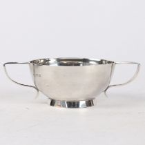 A SOLID SILVER ART DECO TWO HANDLED BOWL.