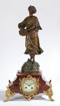 A LATE 19TH CENTURY PATINATED SPELTER AND ROUGE MARBLE MANTLE CLOCK.