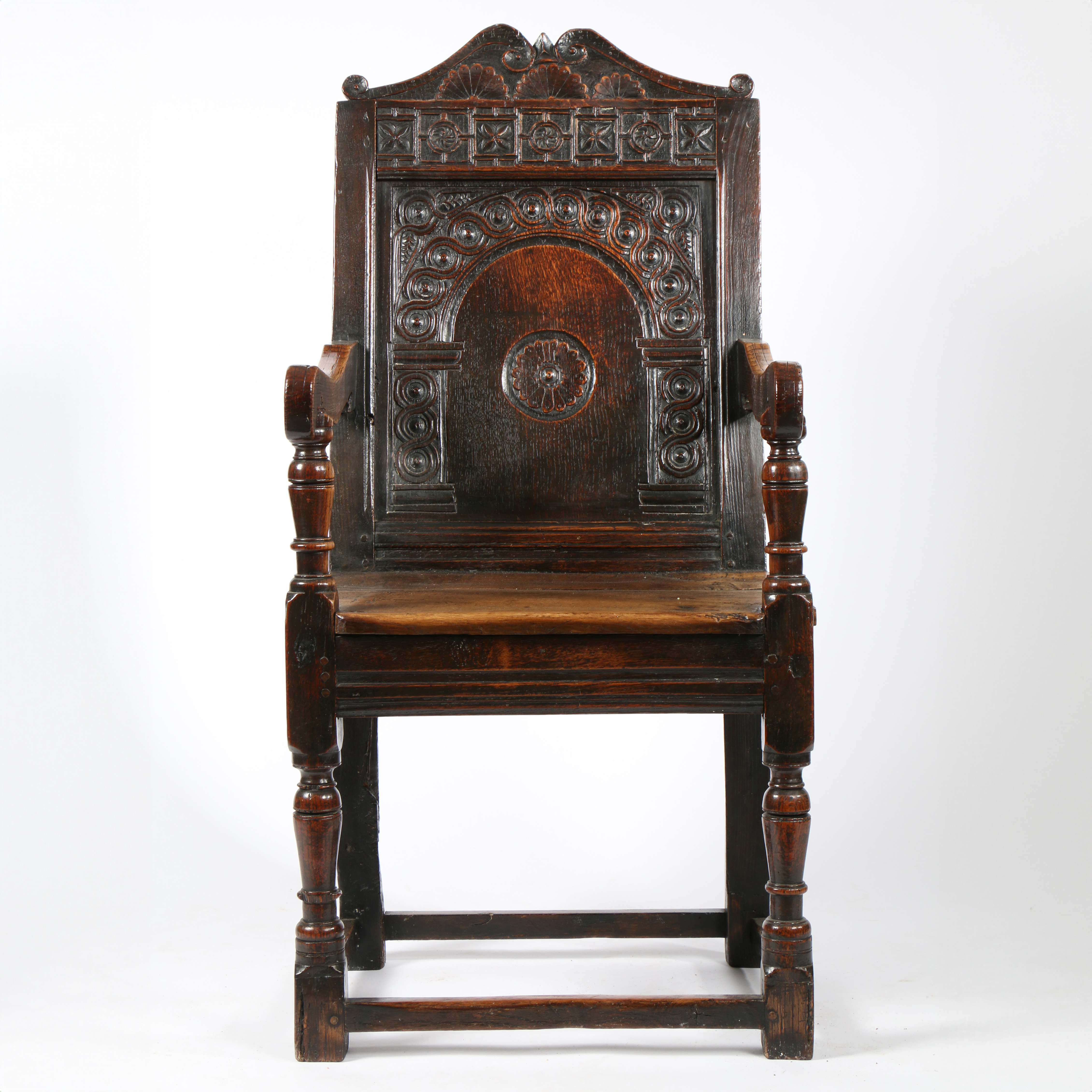 A CHARLES I OAK PANEL-BACK OPEN ARMCHAIR, CIRCA 1640.