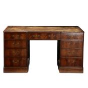 A GEORGE III STYLE MAHOGANY DESK OF BREAKFRONT FORM.