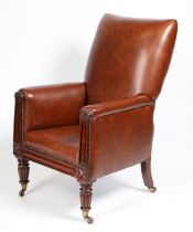 A 19TH CENTURY LEATHER UPHOLSTERED ARMCHAIR.