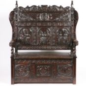 A 19TH CENTURY OAK SETTLE IN THE 17TH CENTURY MANNER.