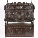 A 19TH CENTURY OAK SETTLE IN THE 17TH CENTURY MANNER.