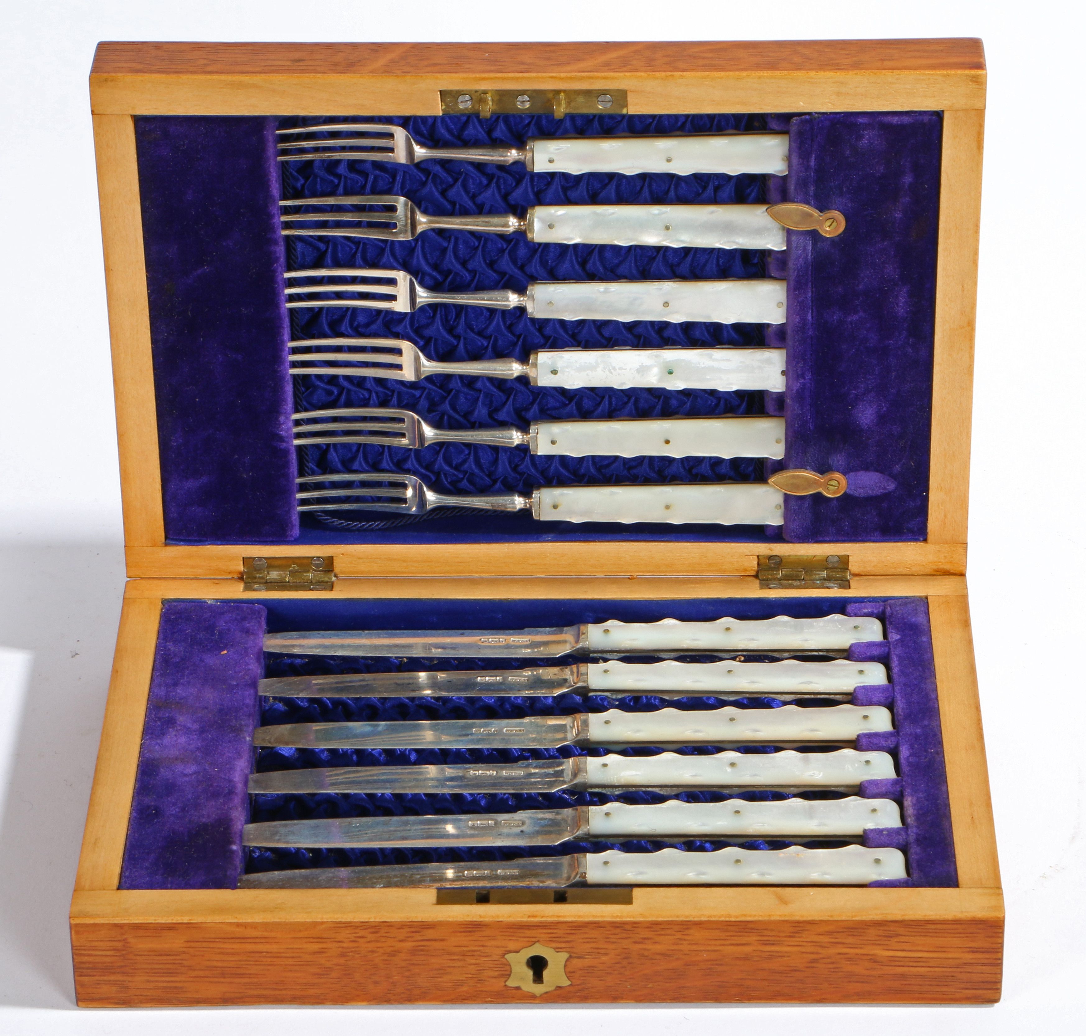 AN EDWARDIAN CASED SET OF SILVER AND MOTHER OF PEARL KNIVES AND FORKS.