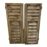 A PAIR OF VINTAGE FRENCH WINDOW SHUTTERS.