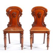 A PAIR OF VICTORIAN ARMORIAL BACK MAHOGANY HALL CHAIRS ATTRIBUTED TO W. BLACKIE.