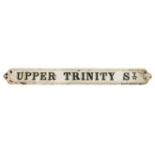 A VICTORIAN SCROLL CAST IRON STREET SIGN 'UPPER TRINITY STREET'.