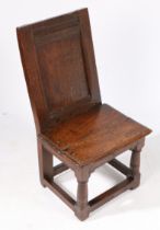 A RARE ELIZABETH I/JAMES I OAK LOW BACKSTOOL, OR CHILD’S CHAIR, CIRCA 1600-20.