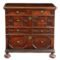 A CHARLES II OAK GEOMETIRC CHEST OF DRAWERS, CIRCA 1660.