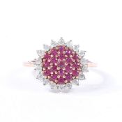 A YELLOW METAL, RUBY AND DIAMOND CLUSTER RING.