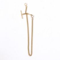 AN 18 CARAT GOLD POCKET WATCH CHAIN AND T BAR.