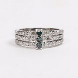 A 14 CARAT WHITE GOLD, EMERALD AND DIAMOND RING.