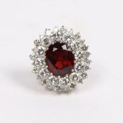 A SUBSTANTIAL DIAMOND AND GARNET CLUSTER RING.