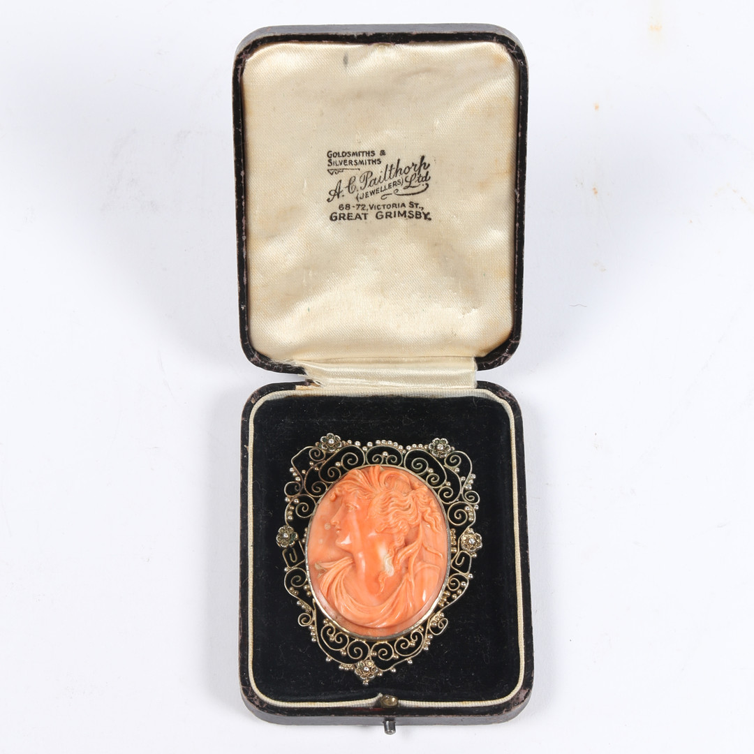 A SILVER GILT CORAL CAMEO BROOCH.