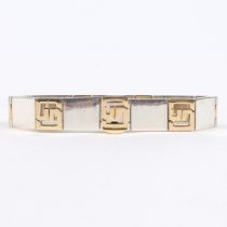 A GUCCI 18 CARAT GOLD AND SILVER BRACELET.