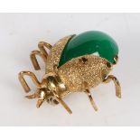 AN 18 CARAT GOLD AND GREEN PASTE LADYBIRD BROOCH.